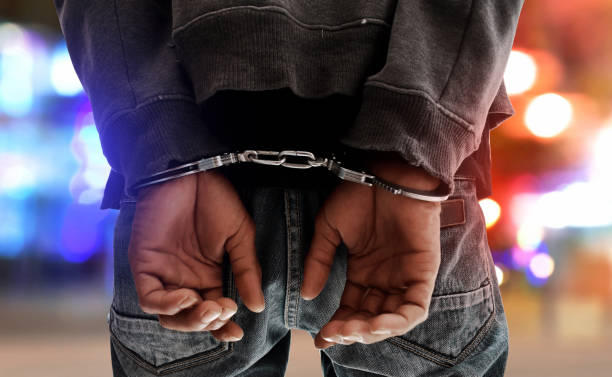 a picture of a man in handcuffs PHOTO| Istock