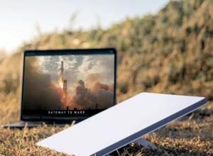 Starlink router next to a laptop PHOTO| Techweez