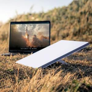 Starlink router next to a laptop PHOTO| Techweez